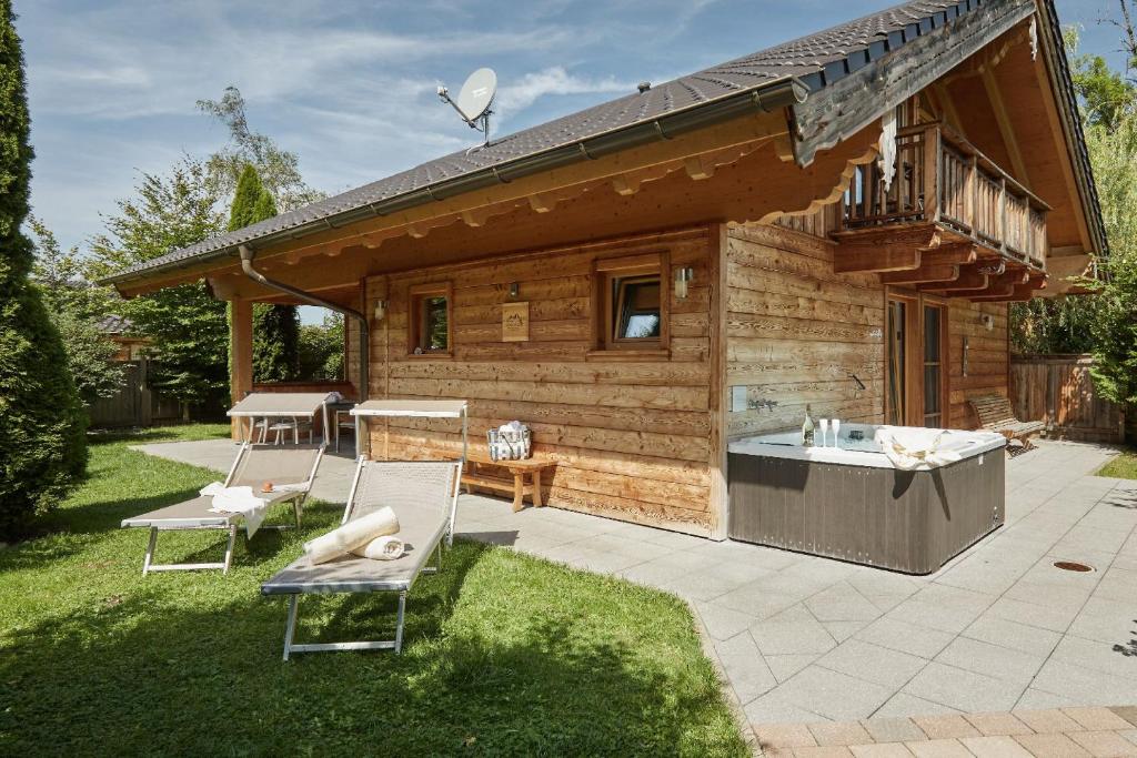 Cabaña de madera con bañera en un patio en Bayern Chalets en Ainring