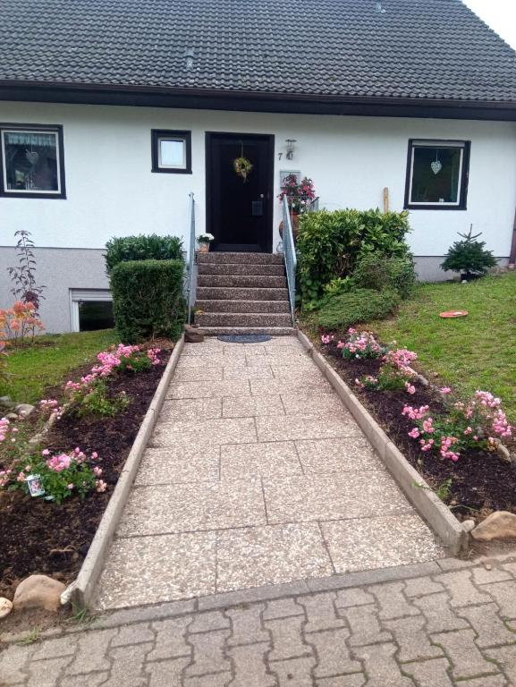 a walkway leading to the front door of a house at Haus am Römerstich in Auen