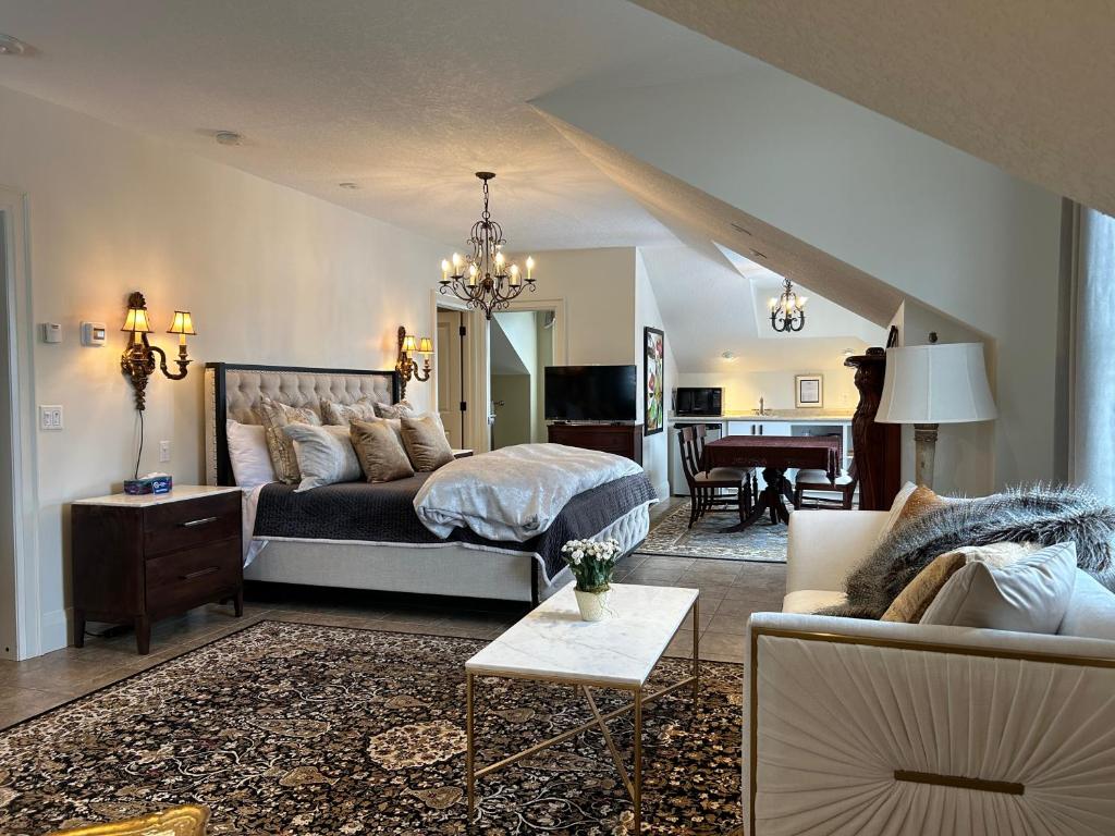 a bedroom with a bed and a living room at Norfolk Guest House Inn in Guelph