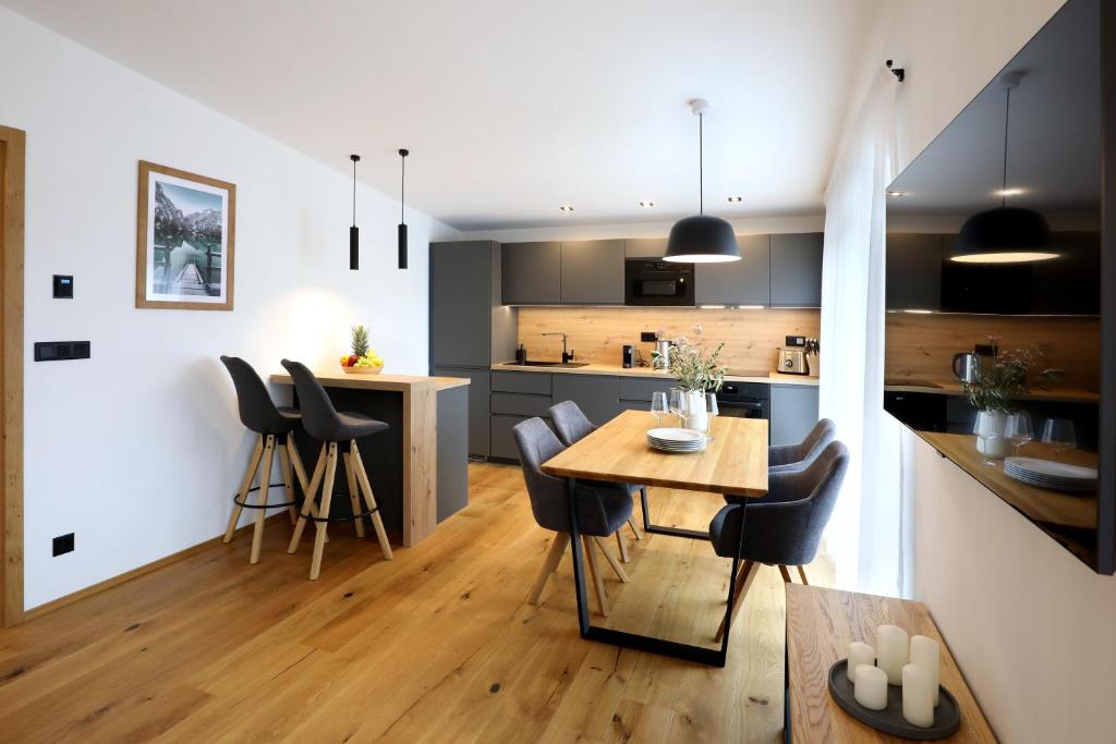 a kitchen and dining room with a table and chairs at Apartmány Horizont in Loučná pod Klínovcem