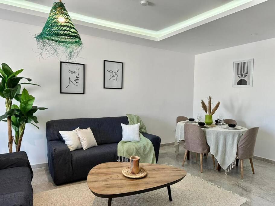 a living room with a couch and a table at Saf-Saf Apartment 2 in La Marsa