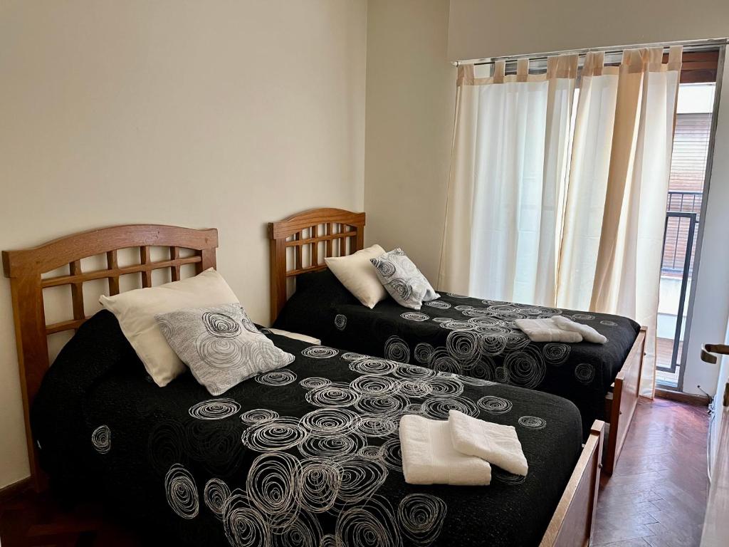 a bedroom with two beds and a window at The best experience and service in Mendoza