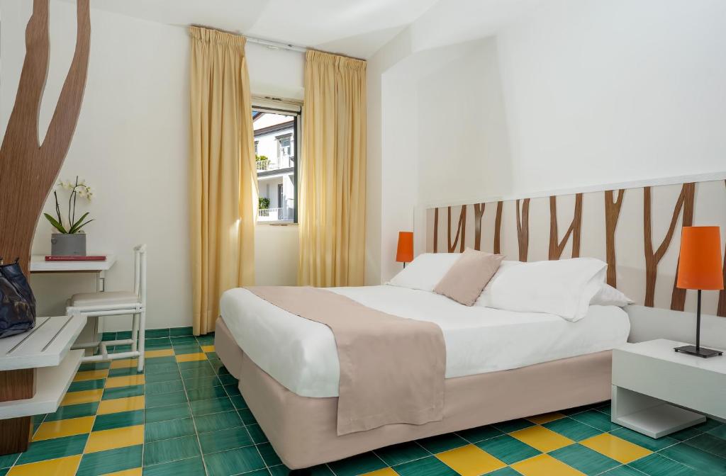 Postel nebo postele na pokoji v ubytování Hotel Le Axidie