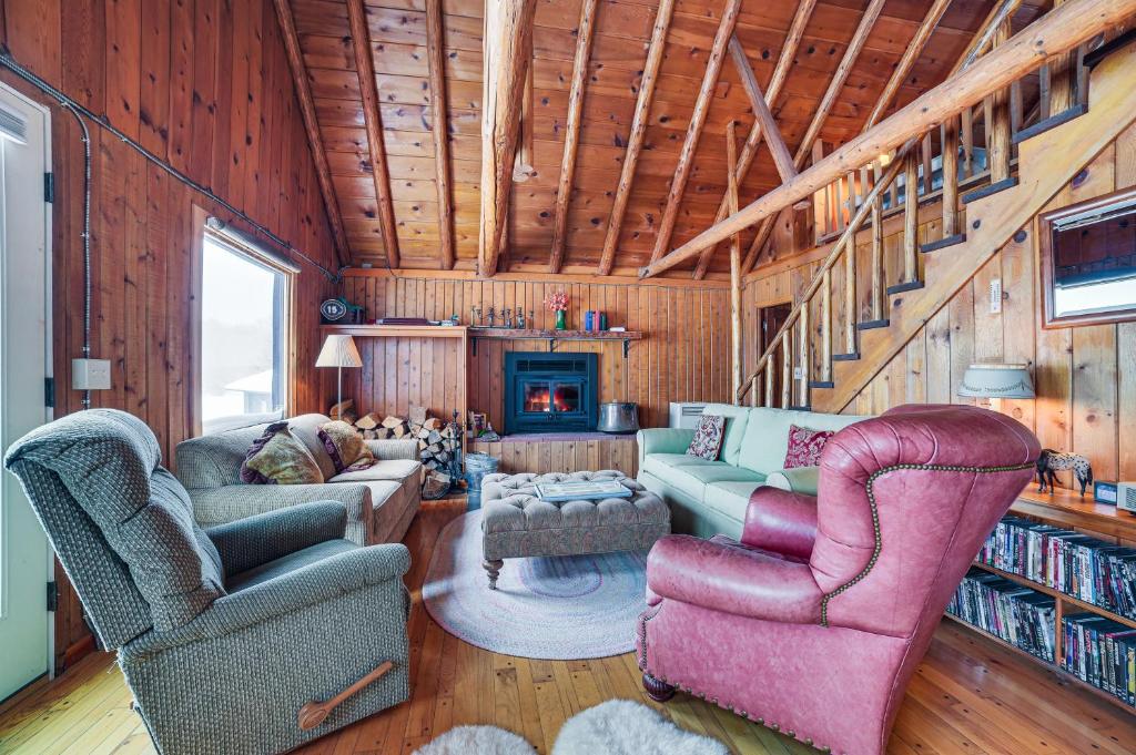 a living room with two couches and a fireplace at Michigan Cabin Retreat 5 Mi to Sturgeon Bay Beach in Pellston