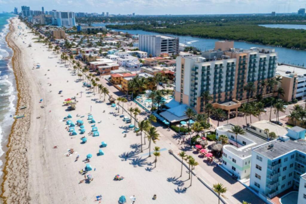 an aerial view of a beach with people and umbrellas at Walkabout 6 Suite on Hollywood Beach with Ocean Views in Hollywood