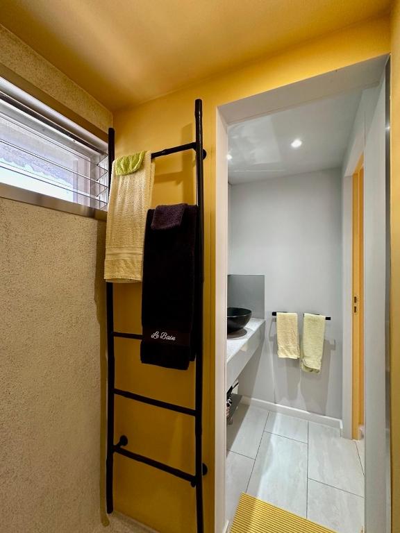 a small room with a bunk bed and a bathroom at Sun Caraibes in Orient Bay