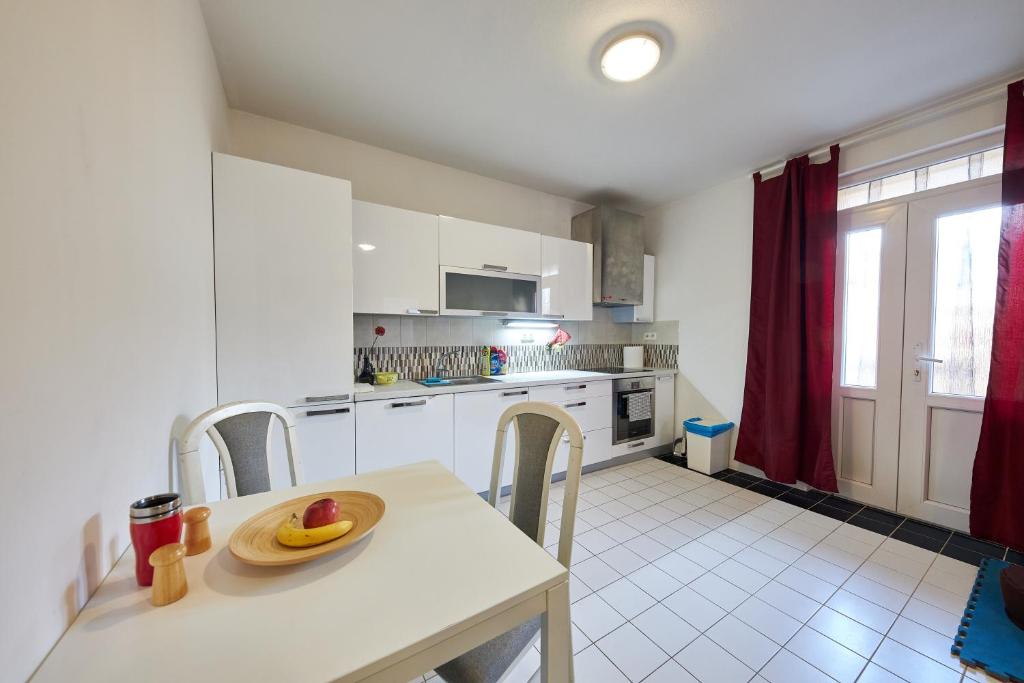 a kitchen with a table with a plate of fruit on it at Relax apartment Bratislava in Bratislava