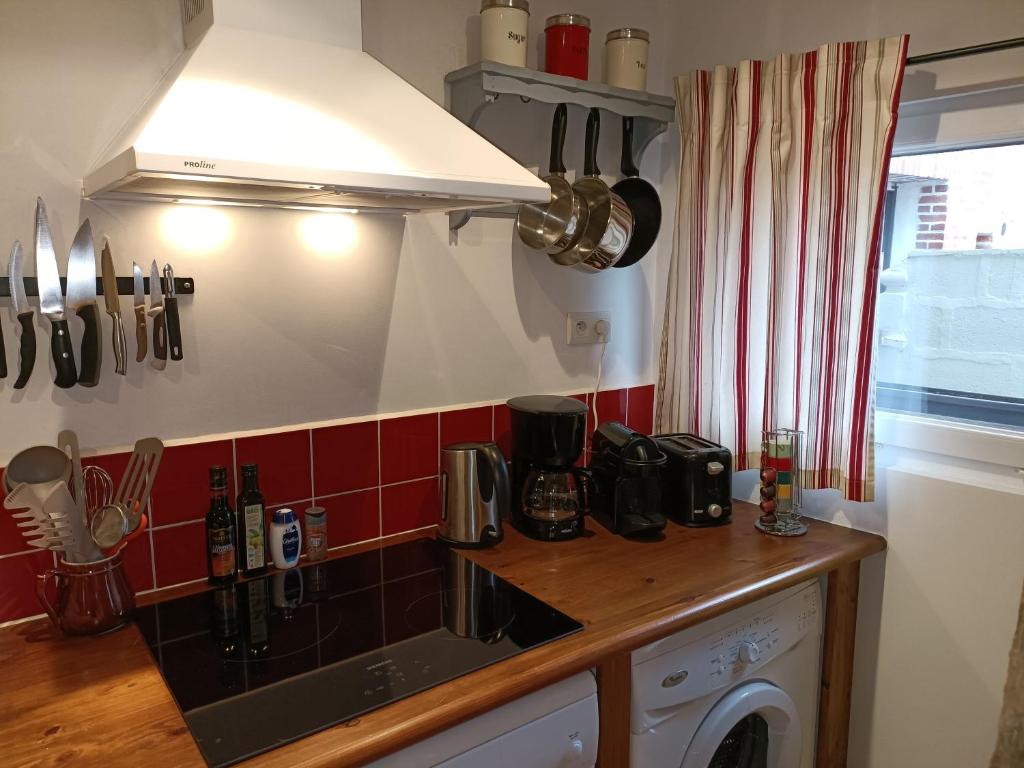 a kitchen with a sink and a stove top oven at Lovely cottage in Honfleur center in Honfleur