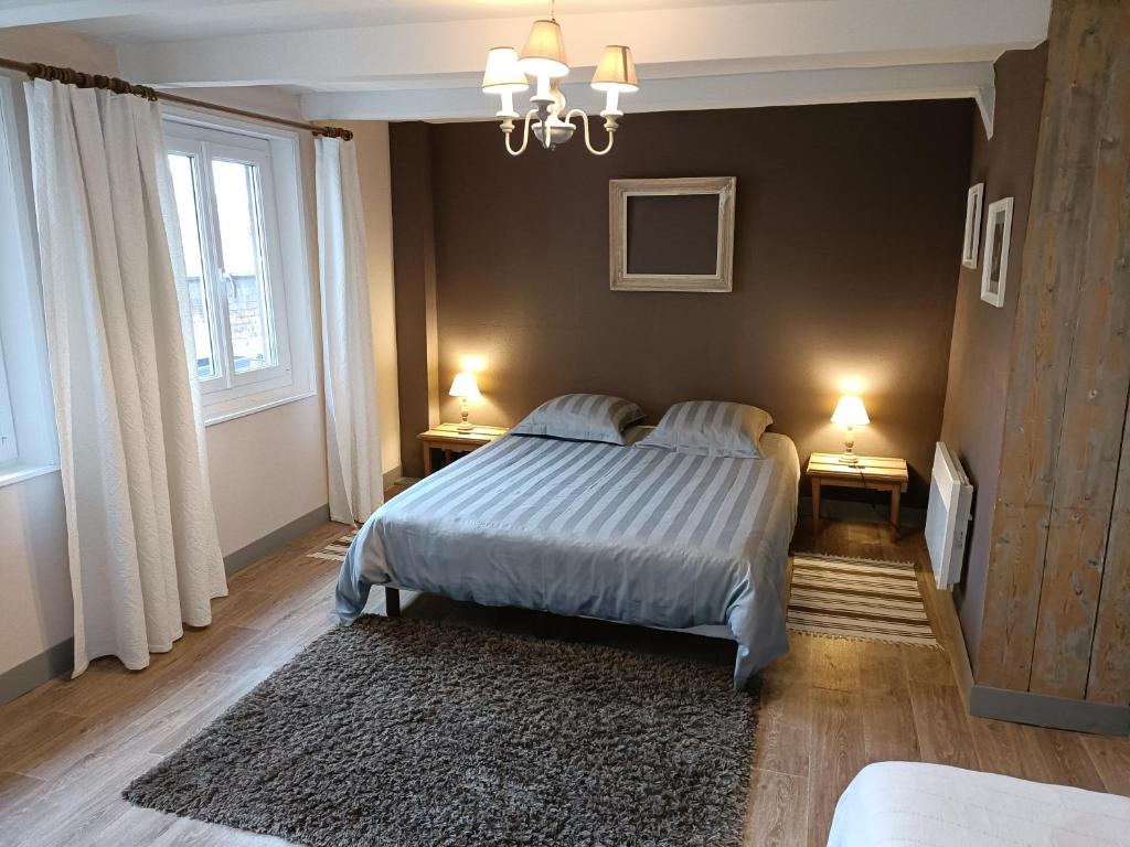 a bedroom with a bed and two lamps on two tables at Lovely cottage in Honfleur center in Honfleur