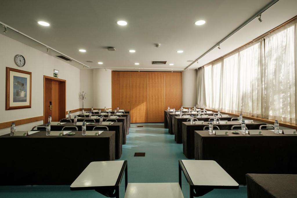 A formal classroom meeting room with a wood-panelled front wall.
