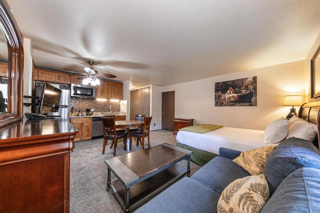 a hotel room with a couch and a table at Studio Queen Room Ground Floor Unit 113 Bldg B in Truckee