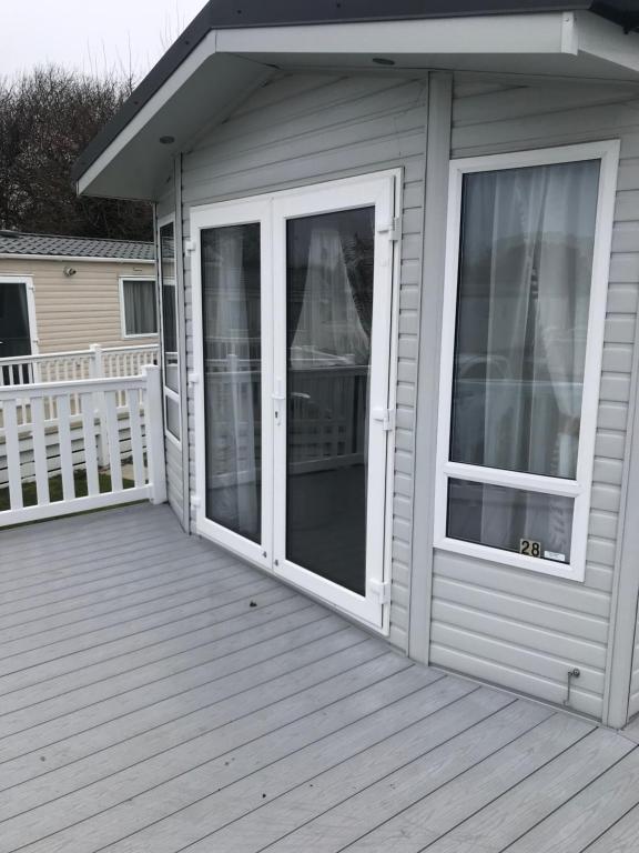 a porch with sliding glass doors on a house at The Willows in Selsey