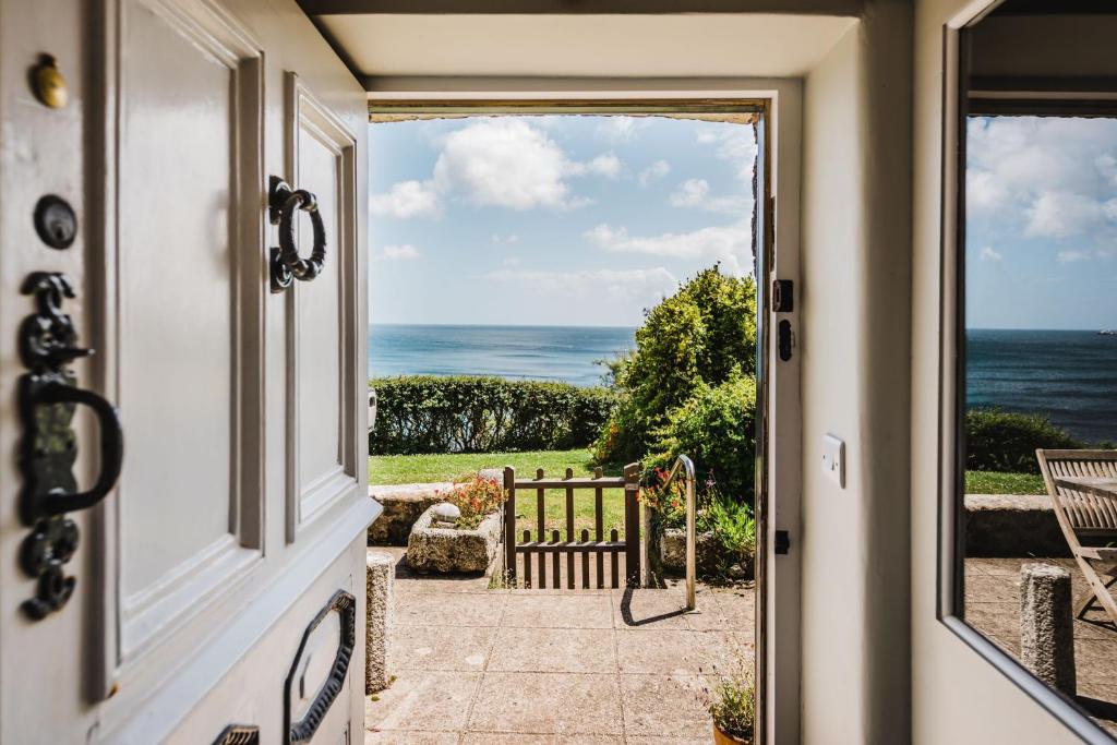 an open door to the ocean from a house at Prospect House in Coverack
