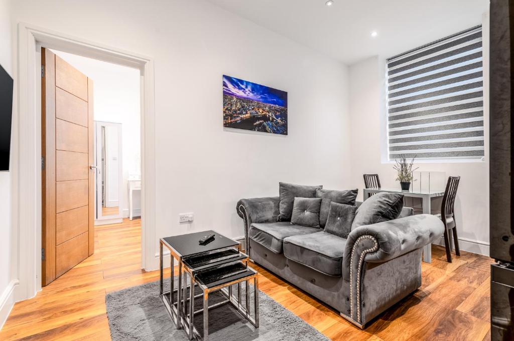 a living room with a couch and a table at Livestay Stylish 1-Bed Apartment in Stratford in London