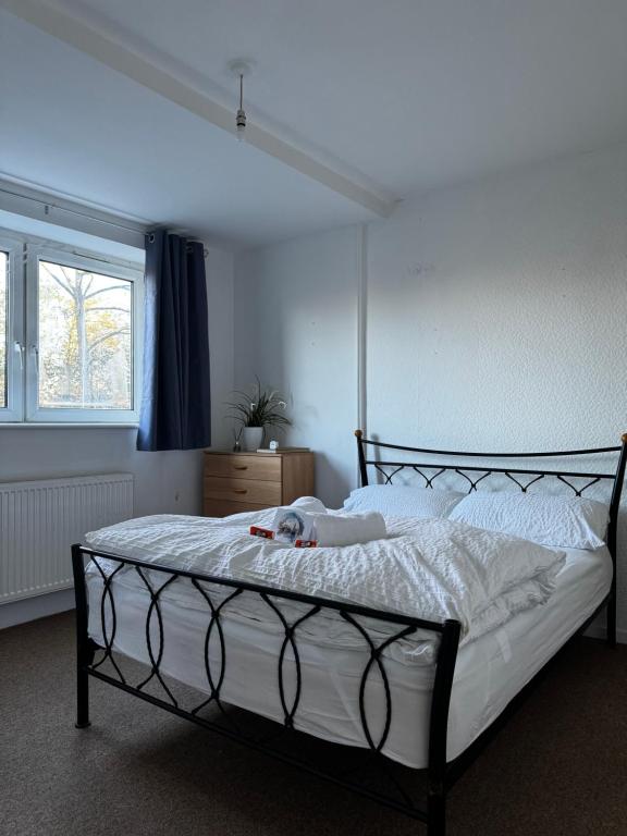 a bedroom with a large bed with white sheets at Double room in Tooting Bec in London