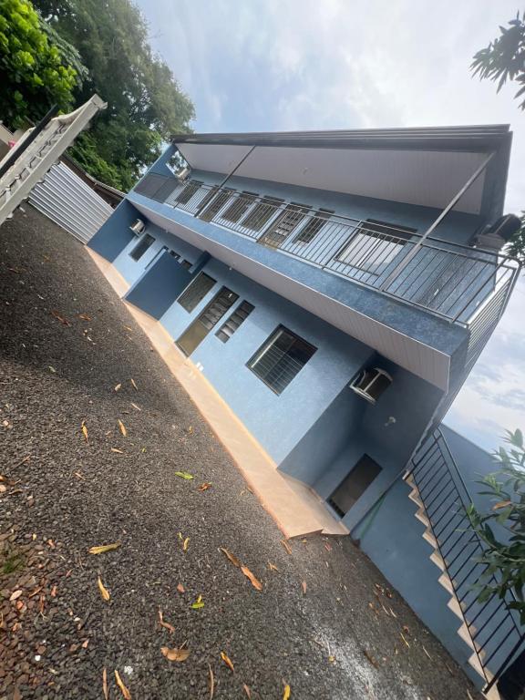 a view of a house with a blue facade at Boicy Residence in Foz do Iguaçu