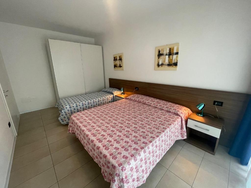 Postel nebo postele na pokoji v ubytování Villa Marina Apartments - Agenzia Cocal