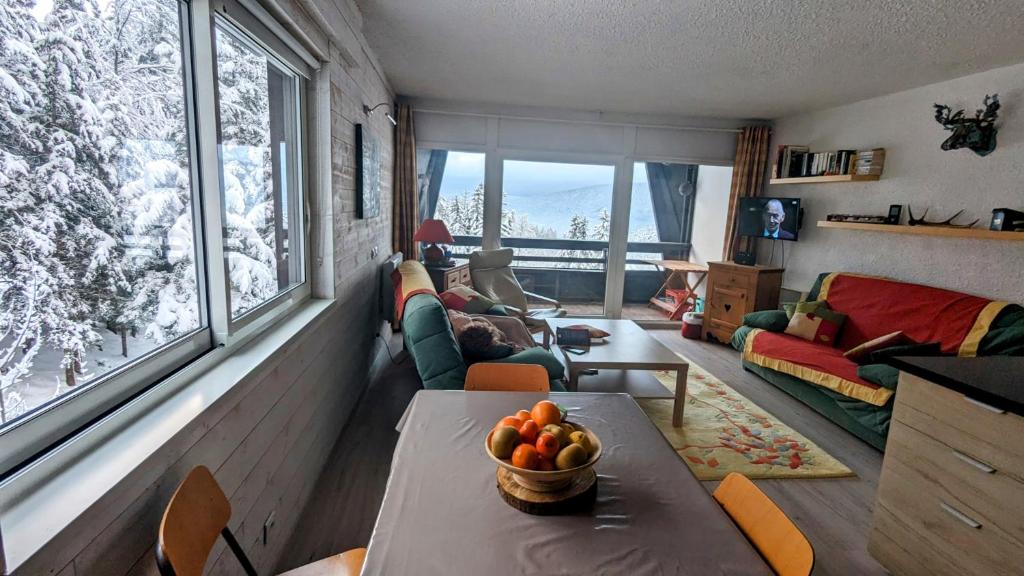 a living room with a table with a bowl of fruit on it at Appartement- Villard de Lans-8 pers in Villard-de-Lans