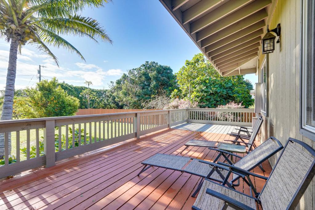 a deck with three chairs and a palm tree at Peaceful Naalehu Paradise 5 Mi to Beach! in Naalehu