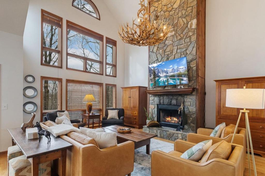a living room with a couch and a fireplace at Wycham Place in Boone