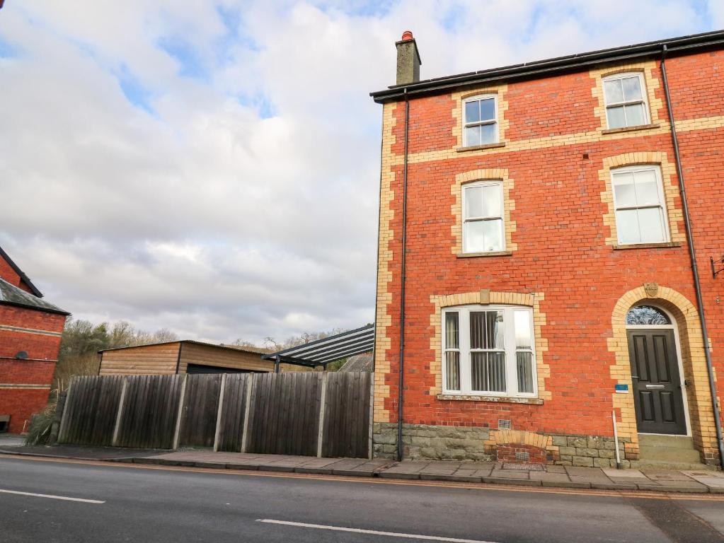 a brick building on the side of a street at Afonwy House in Rhayader