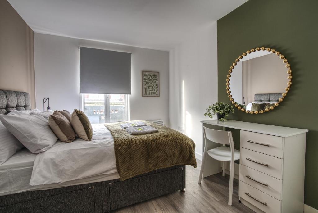 a bedroom with a bed and a mirror and a desk at #59 Phoenix Court By DerBnB, Modern 1 Bedroom Apartment, Wi-Fi, Netflix & Within Walking Distance Of The City Centre in Sheffield