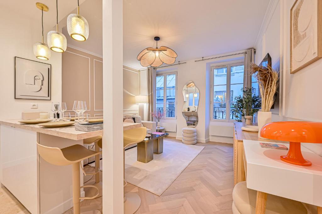 cocina y sala de estar con mesa y sillas en Suite Eiffel- Perfect location en París