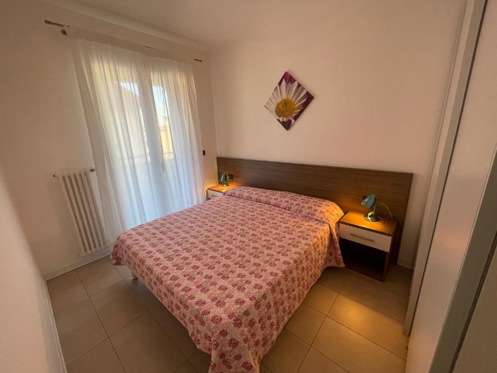 Postel nebo postele na pokoji v ubytování Villa Marina Apartments - Agenzia Cocal