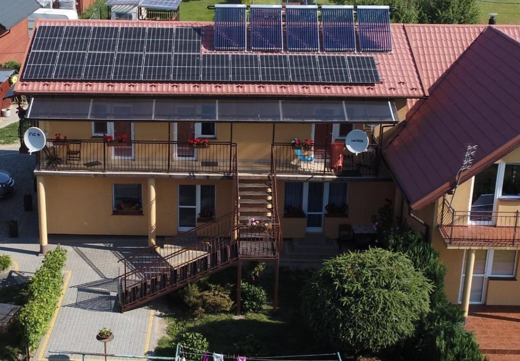 eine Luftansicht eines Hauses mit Sonnenkollektoren auf dem Dach in der Unterkunft "Pokoje u Ireny"-pokój brzoza 4 osobowy in Sztutowo
