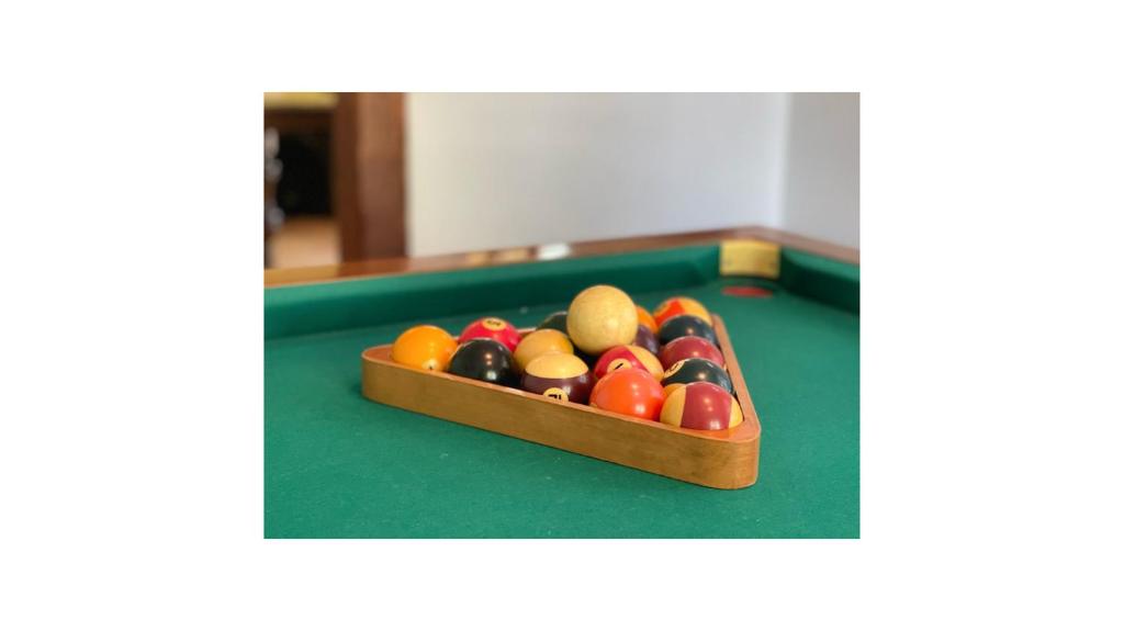 a box of billiard balls on a pool table at Chambres d&#39;hôtes la Soulenque Luxury B &amp; B in Capestang