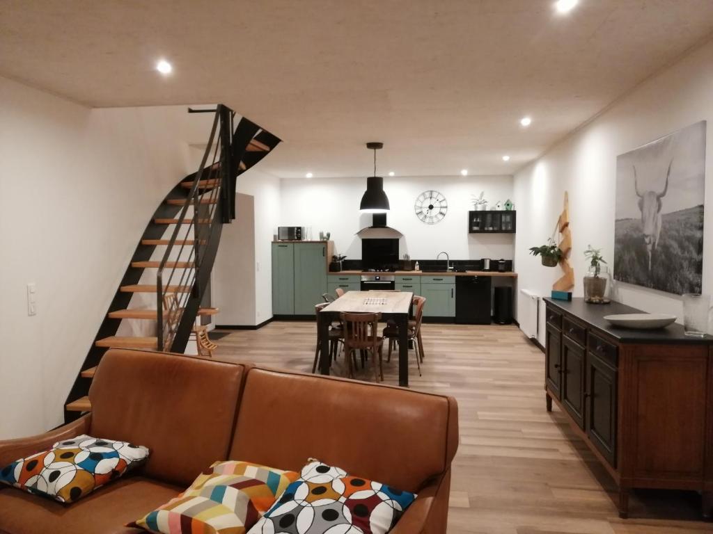 a living room with a couch and a table at Gîte du noisetier aux Granges du Vilaret in Clairvaux-les-Lacs