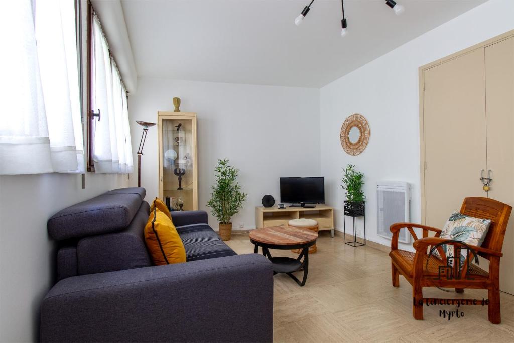 a living room with a couch and a table at Au cœur des Lices in Albi