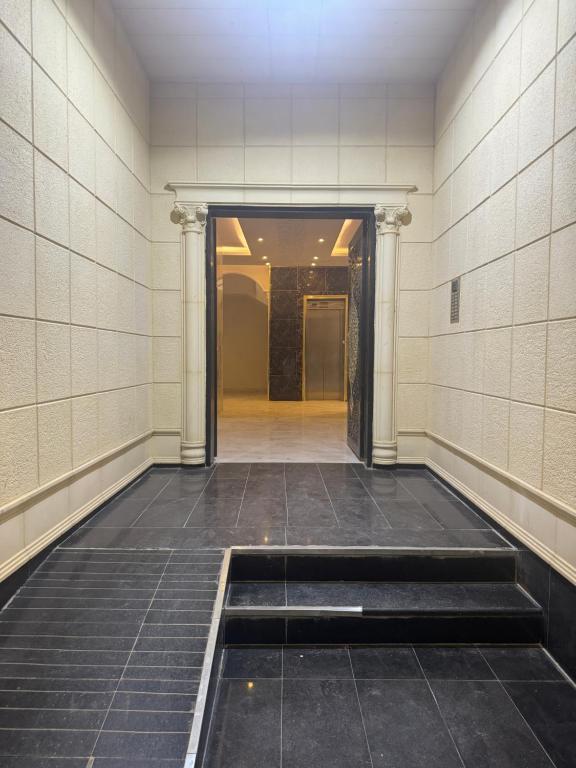 an empty hallway of a building with ailed floor at Narcissus suite in Riyadh