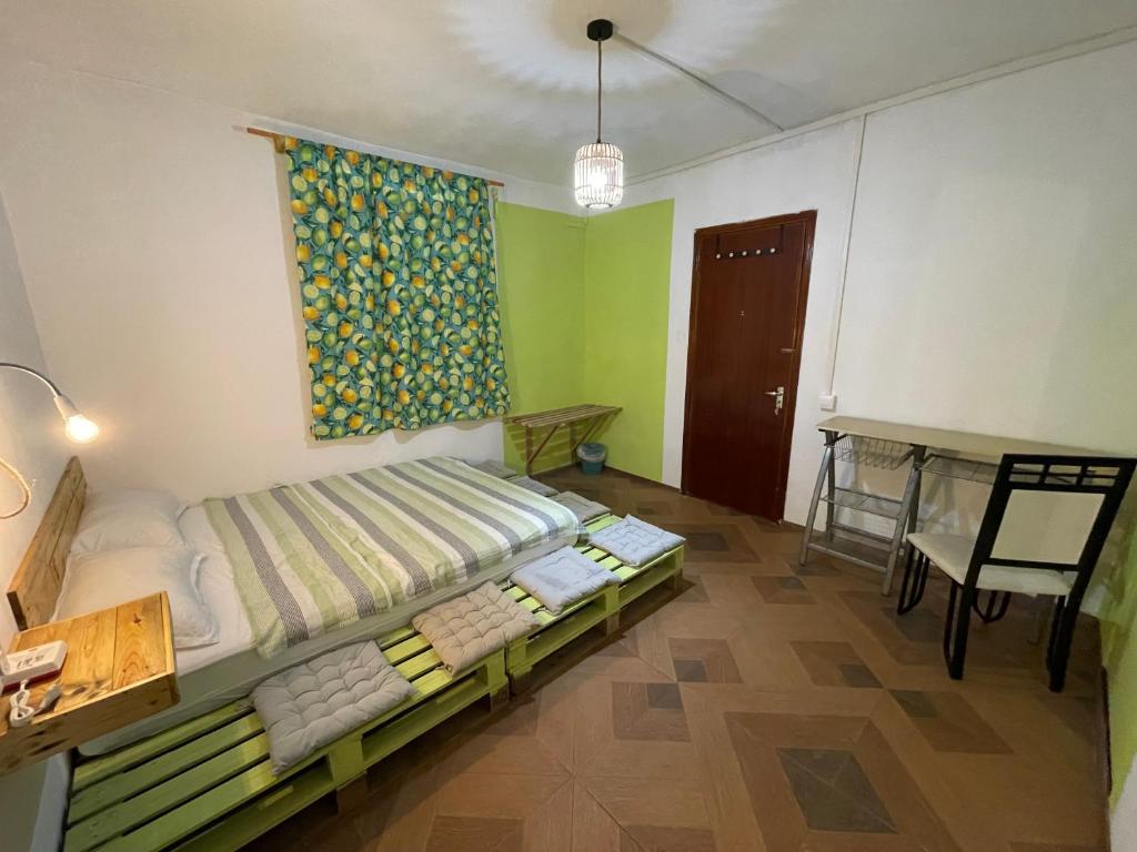 a bedroom with a bed and a table in it at Kowlessur Residence in Surinam