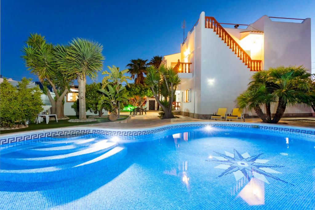 a swimming pool in front of a villa at Villa Mali in Ibiza Town