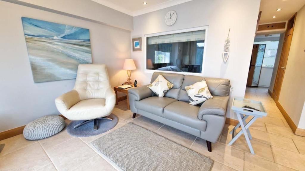 a living room with a couch and a chair at Redcliffe Apartments J in Bishopston