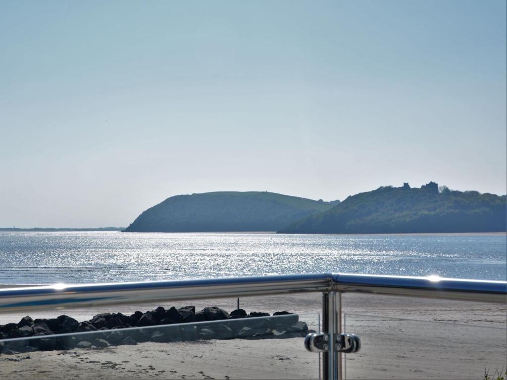 a view of the ocean with mountains in the background at 3 bed in Ferryside 51632 in Ferryside