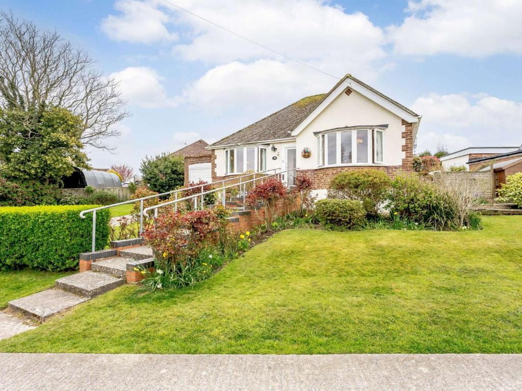 a house with a yard with stairs and flowers at 2 bed in Bexhill on Sea 82747 in Sidley
