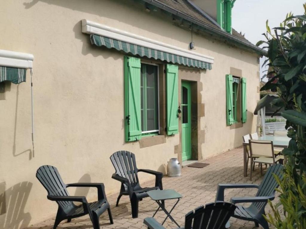 a group of chairs sitting outside of a building at Gîte Saint-Aubin-le-Monial, 4 pièces, 6 personnes - FR-1-489-490 in Saint-Aubin-le-Monial