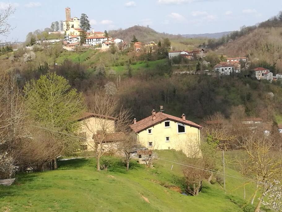 a house sitting on top of a lush green hill at casa nel verde Cà dla cola in Mombasiglio