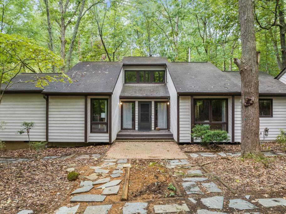 une maison blanche avec un arbre en face dans l'établissement Large, private home on forested lot in Chapel Hill, à Chapel Hill