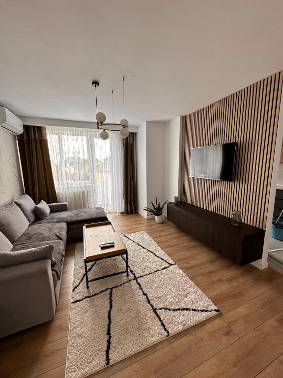 a living room with a couch and a table at Dreambed 2 in Baia Mare
