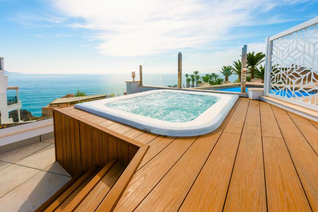 a hot tub on the deck of a house at HC Calahonda Beach Nerja in Nerja
