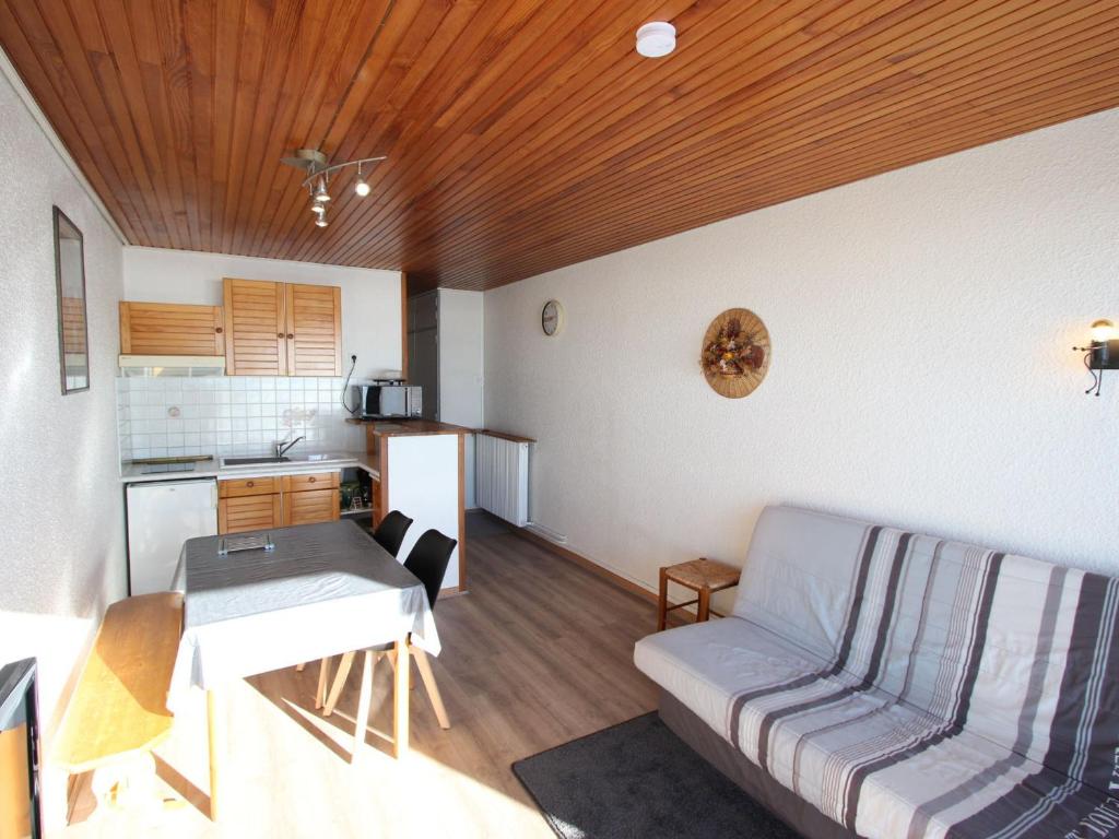 a living room with a couch and a table at Studio Chamrousse, 1 pièce, 4 personnes - FR-1-549-14 in Chamrousse