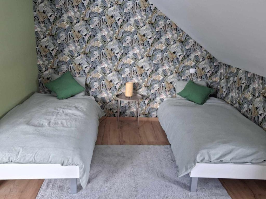 a bedroom with two twin beds and a wall at Lu Bê mont in Stavelot