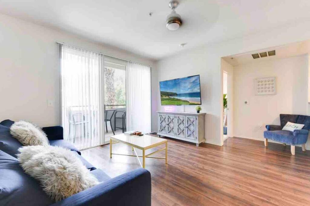 een woonkamer met een blauwe bank en een tafel bij HubLife Your Private Oasis in the Heart of Marina del Rey in Los Angeles