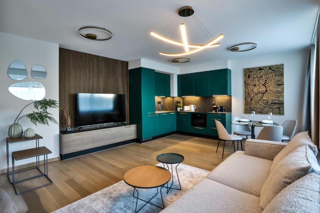 a living room with a couch and a tv at Sun Hill Luxury Suites in Budapest