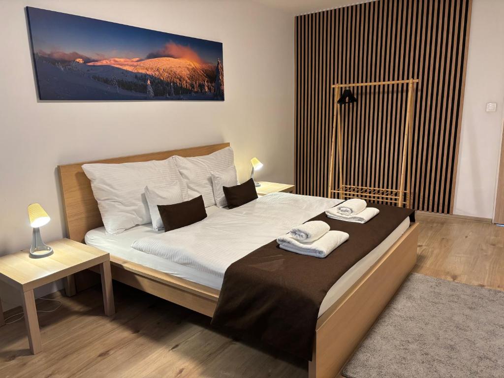 a bedroom with a bed with two towels on it at Apartmán Centrum Komfort in Zvolen