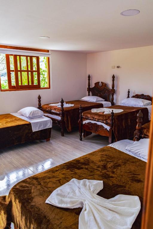 Postel nebo postele na pokoji v ubytování Hotel Campestre La Francesina