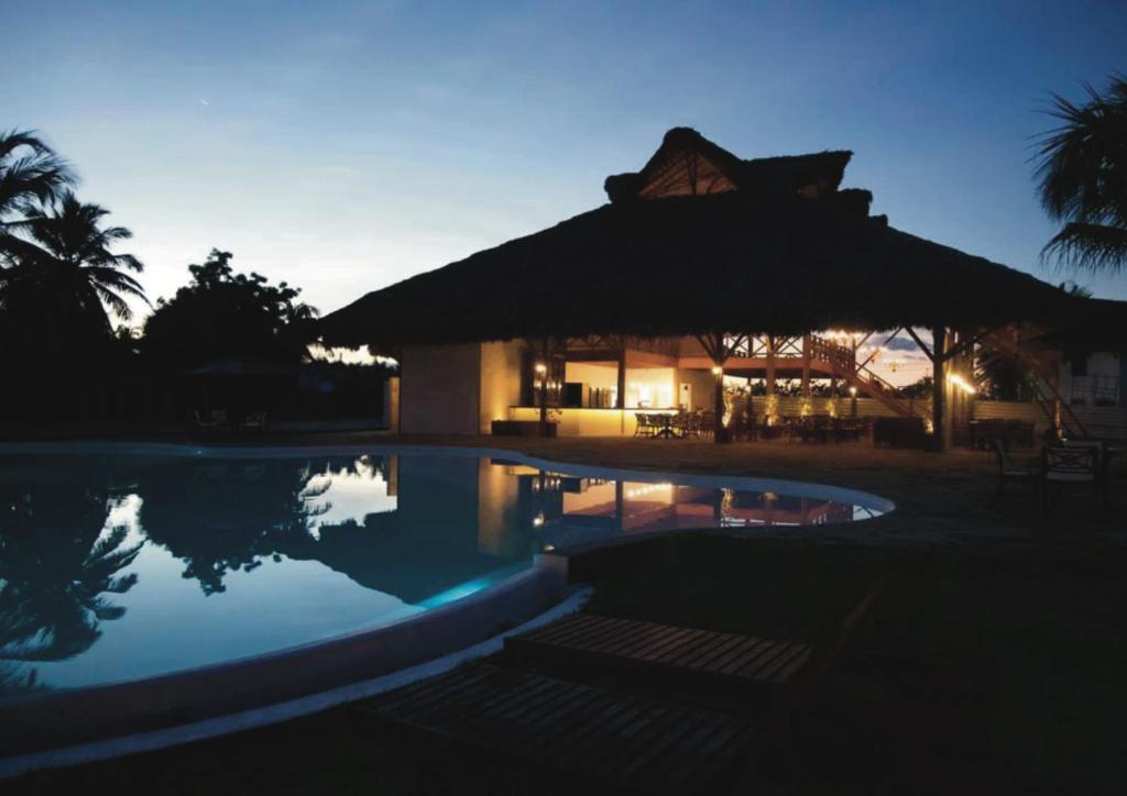 a resort with a swimming pool at night at Villa dos Poetas in Barra Grande